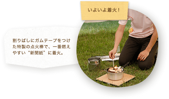 いよいよ着火！割りばしにガムテープをつけた特製の点火棒で、一番燃えやすい“新聞紙”に着火。